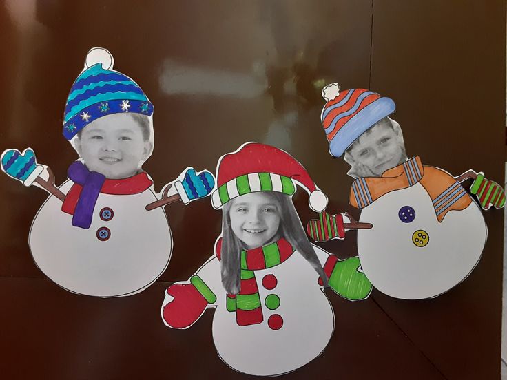 three snowmen with hats and scarves on their heads