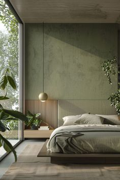 a large bed sitting in a bedroom next to a tall glass wall with plants on it