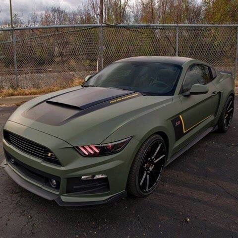 a green mustang parked in a parking lot