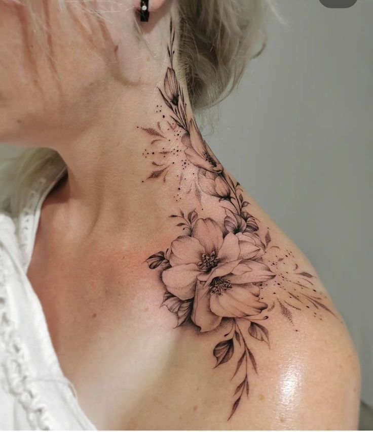 a woman's neck with flowers on it