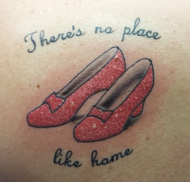 there's no place like home tattoo on the back of a womans stomach