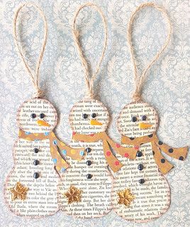 three paper snowmen are hanging from twine with gold stars on each ornament