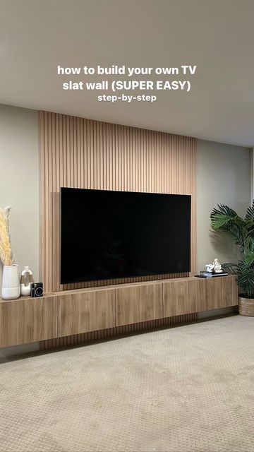 a flat screen tv sitting on top of a wooden entertainment center in a living room