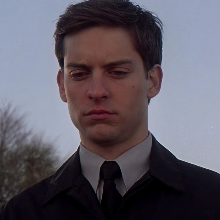 a man wearing a black shirt and tie