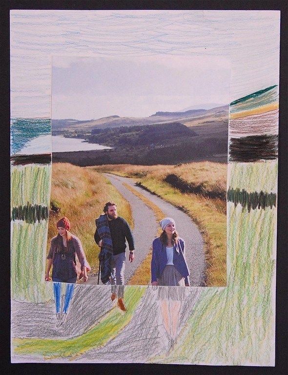 two people walking down a road with grass and hills in the background