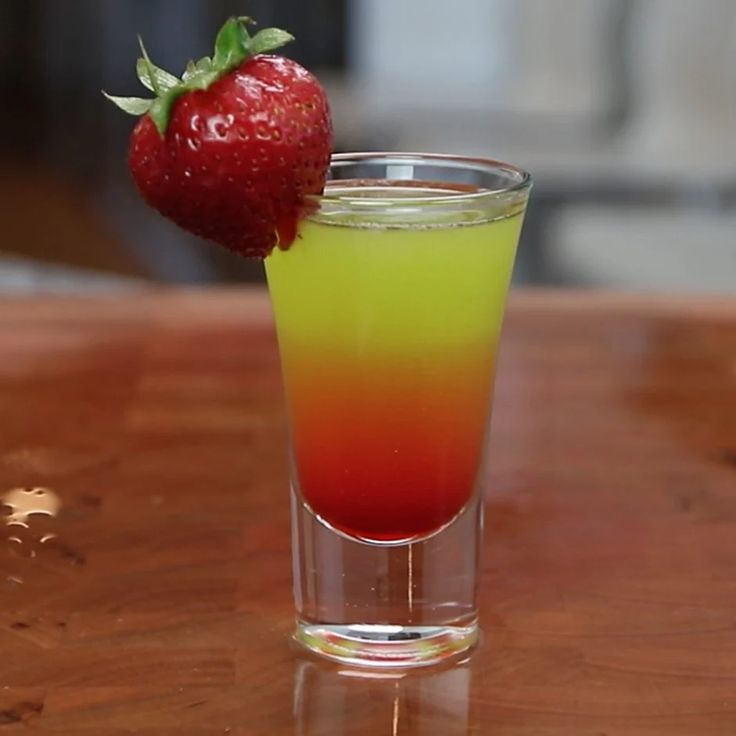 a drink with a strawberry on the rim