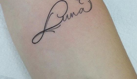 a woman's arm with a tattoo on it that reads, i love you in cursive writing