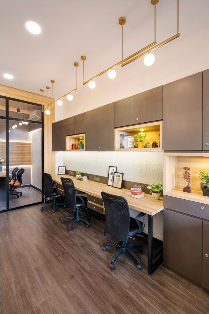 an office space with desks, chairs and cabinets in the center is lit by recessed lights