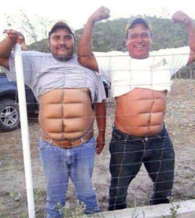 two men standing next to each other behind a fence