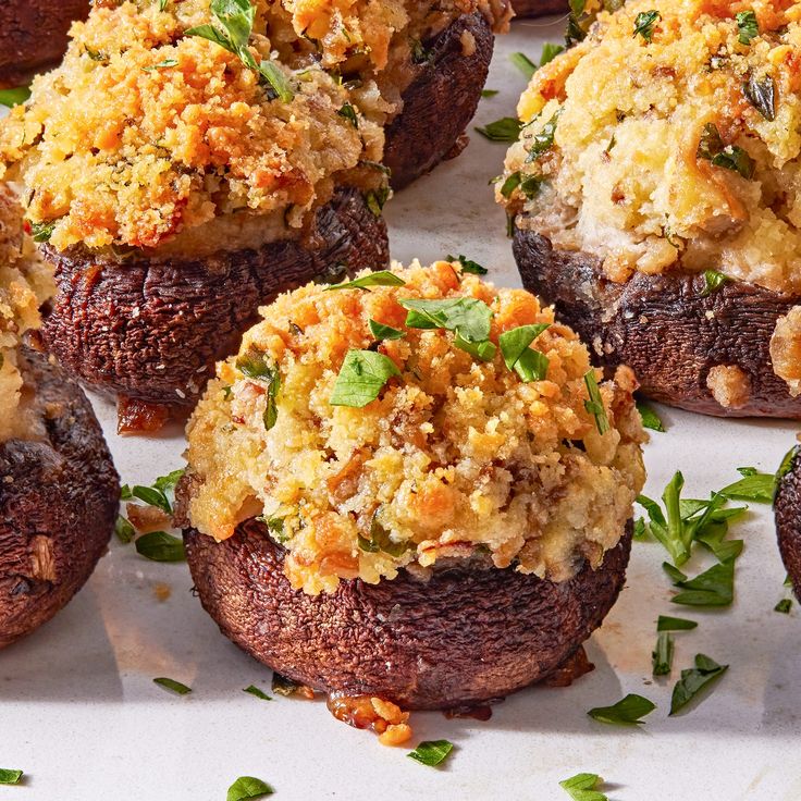 several stuffed mushrooms covered in cheese and herbs