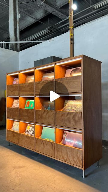 a book shelf with many books on it in a warehouse or office building, and an arrow pointing to the right