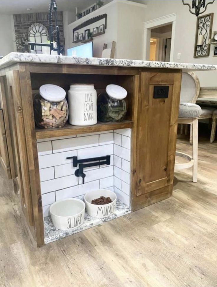 an open cabinet with two bowls and some food on it in the middle of a kitchen