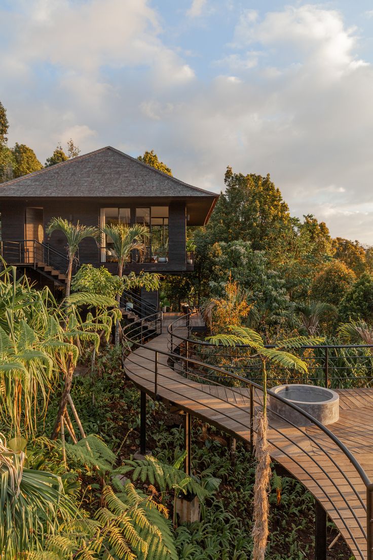 a wooden walkway leading to a gazebo surrounded by trees