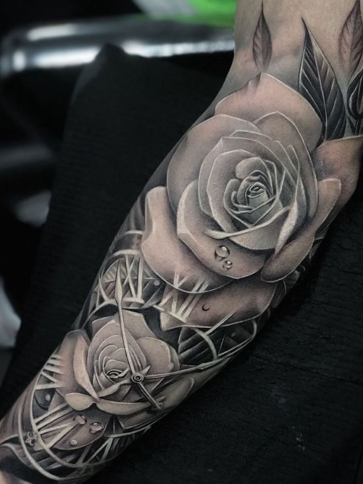 a man with a black and white rose tattoo on his arm