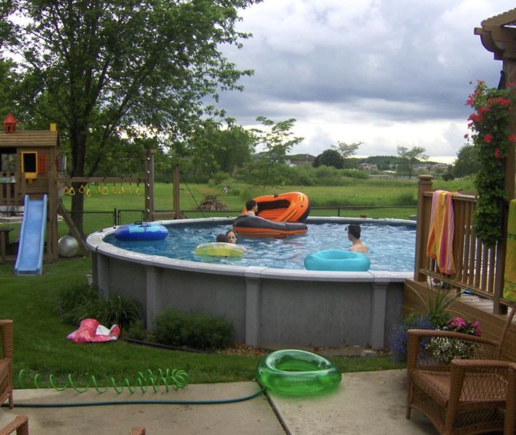 an above ground swimming pool with inflatable rafts and children's toys