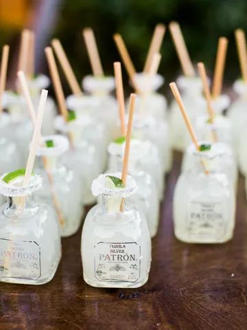 many small glass bottles with sticks sticking out of the top and one filled with liquid