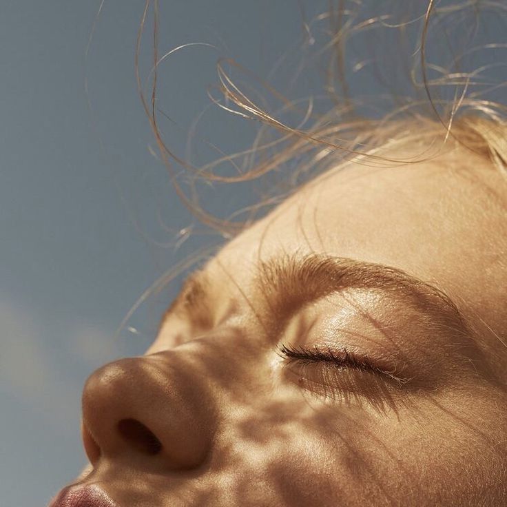 a close up of a child's face with her eyes closed