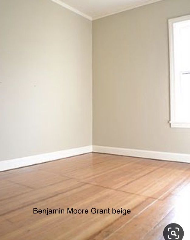 an empty room with hard wood floors and white paint on the walls, in front of a window