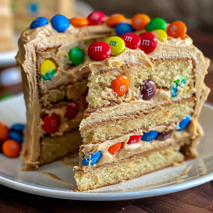 a slice of cake with m and m candies on top is sitting on a plate