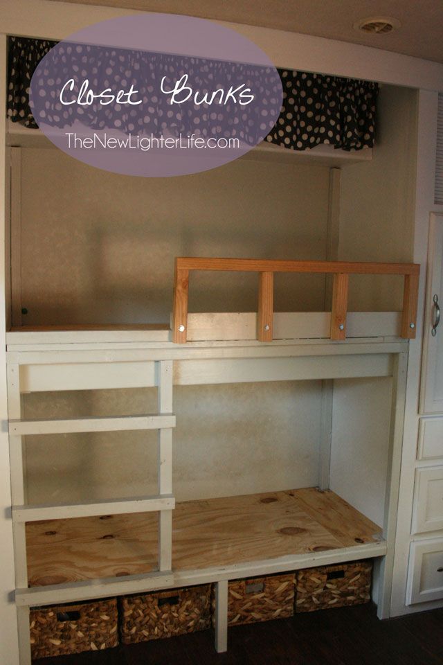 the bunk bed is made out of wood and has two baskets underneath it for storage