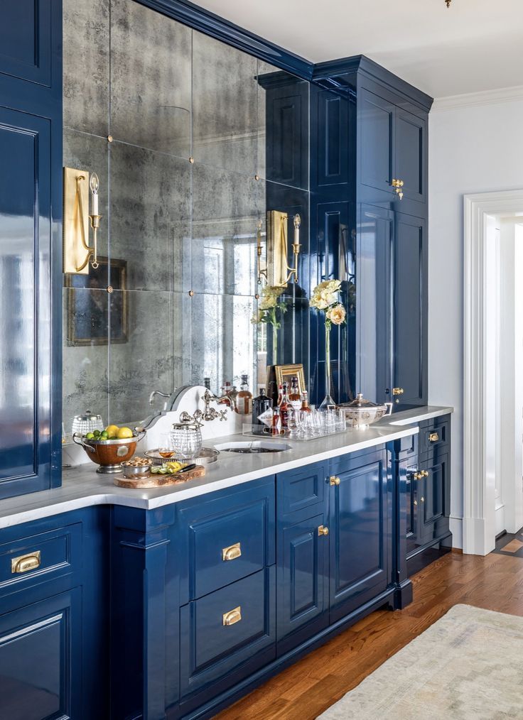 an image of a kitchen with blue cabinets and marble counter tops on the phone screen