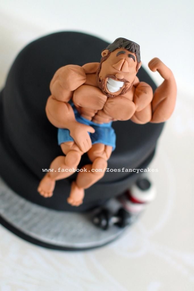 a close up of a cake with a figurine of a man on it