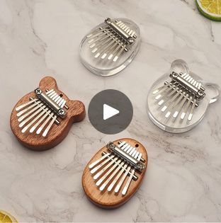 three small wooden combs sitting on top of a marble counter next to lemon slices