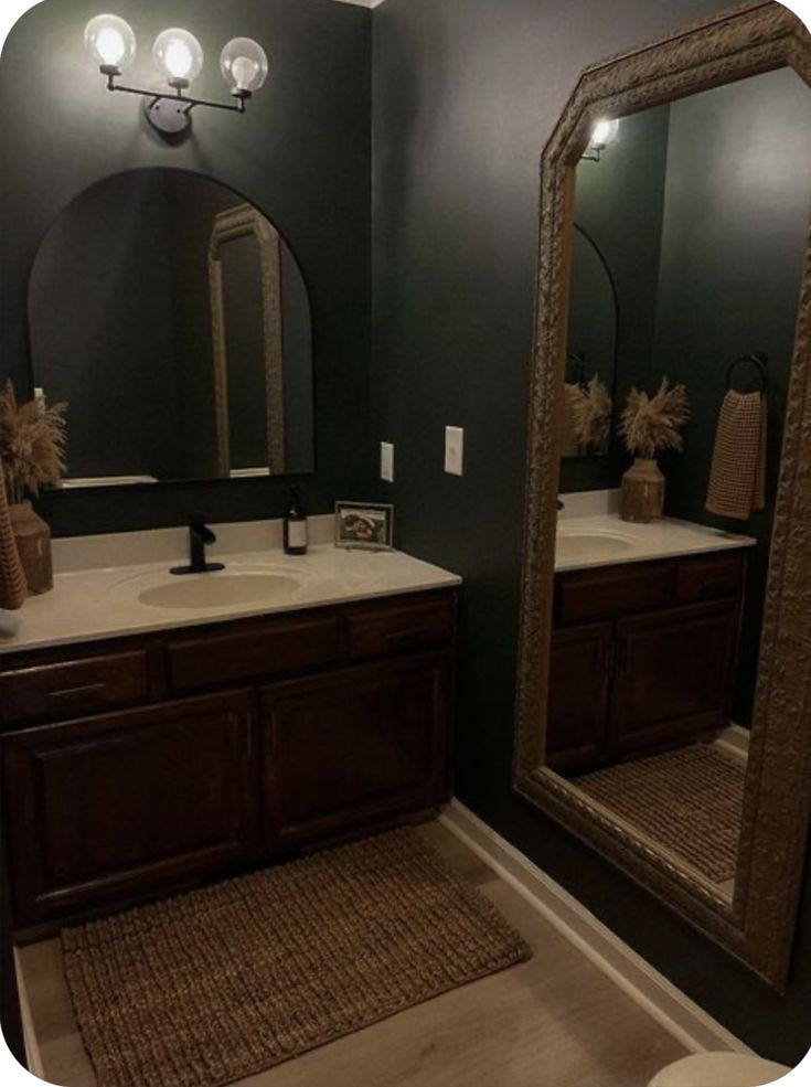 a bathroom with two sinks and mirrors in it