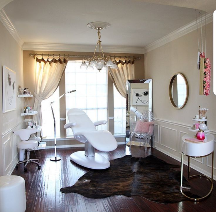 a white chair sitting on top of a wooden floor next to a window in a room