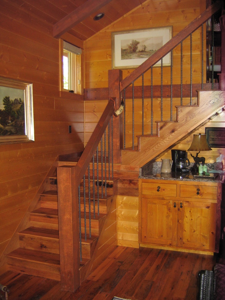 a kitchen and stairs in a wooden house