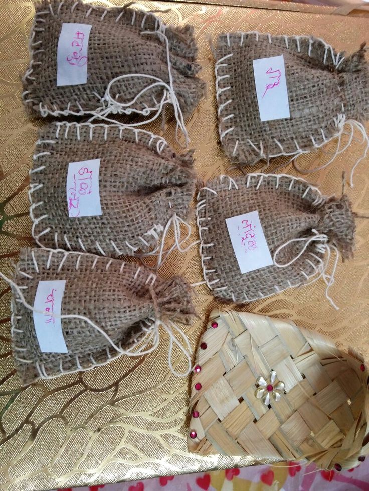 four pieces of burlock with tags on them sitting next to a woven basket