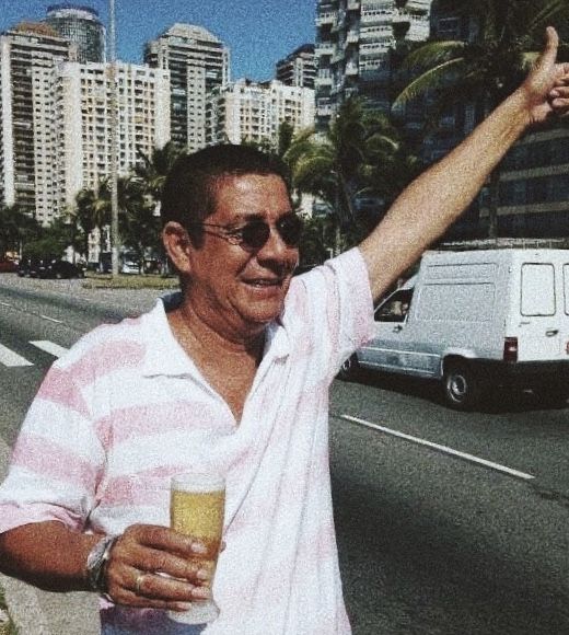 a man is standing on the side of the road with his arm in the air