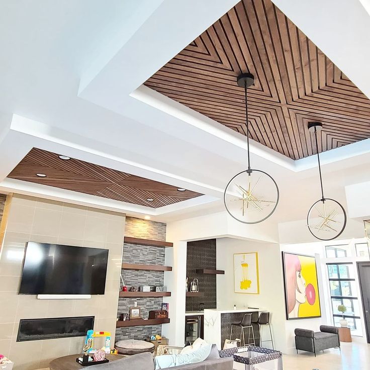 a living room filled with furniture and a flat screen tv mounted to the ceiling over a fire place