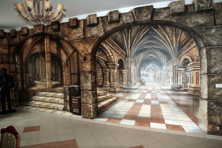 a large mural on the side of a wall in a room with stone arches and pillars