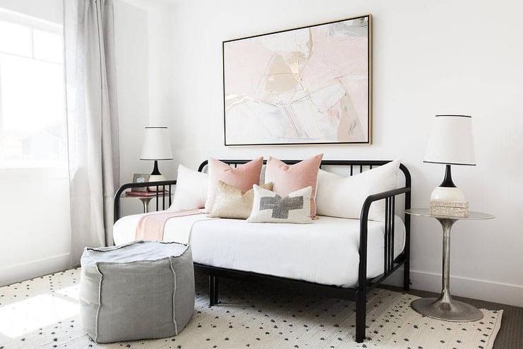 a living room with a white couch and pink pillows