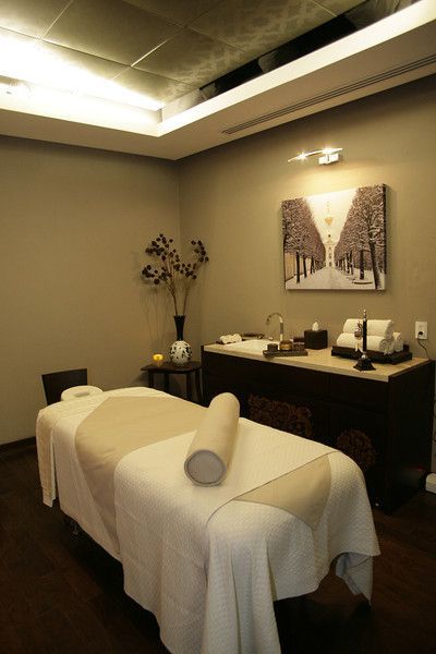 a spa room with white towels on the table