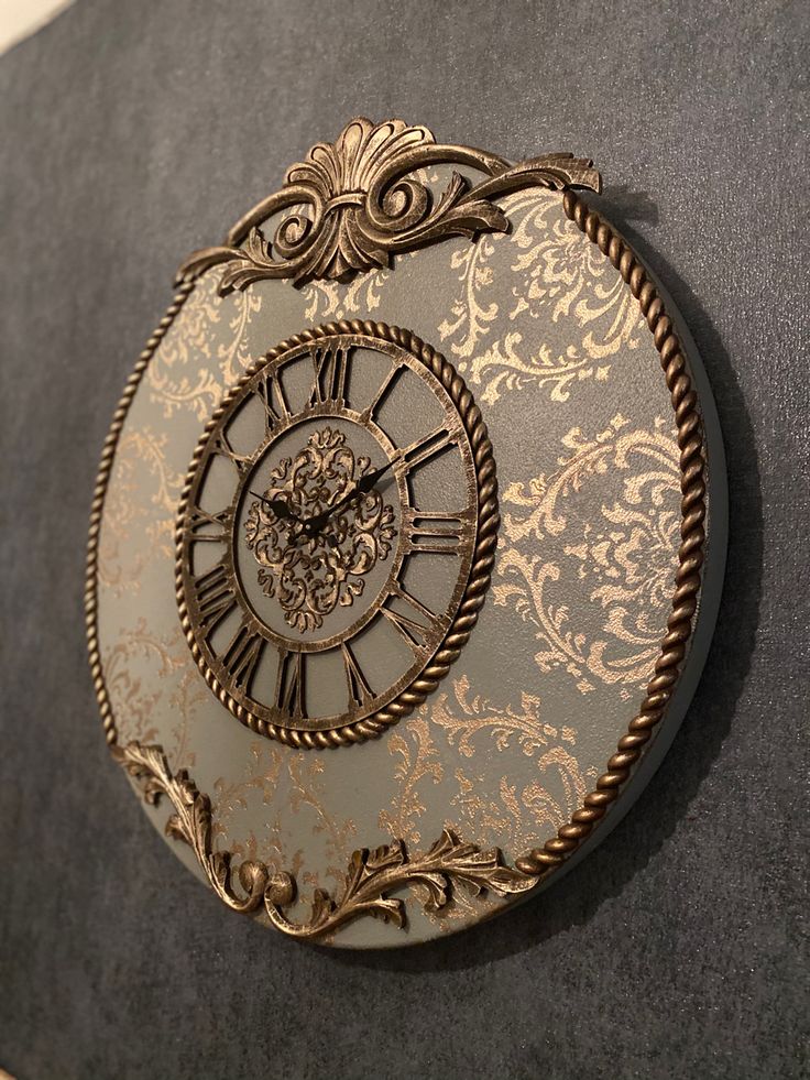 a gold and silver clock on the wall