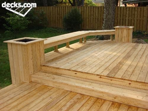 a wooden deck with two benches on it