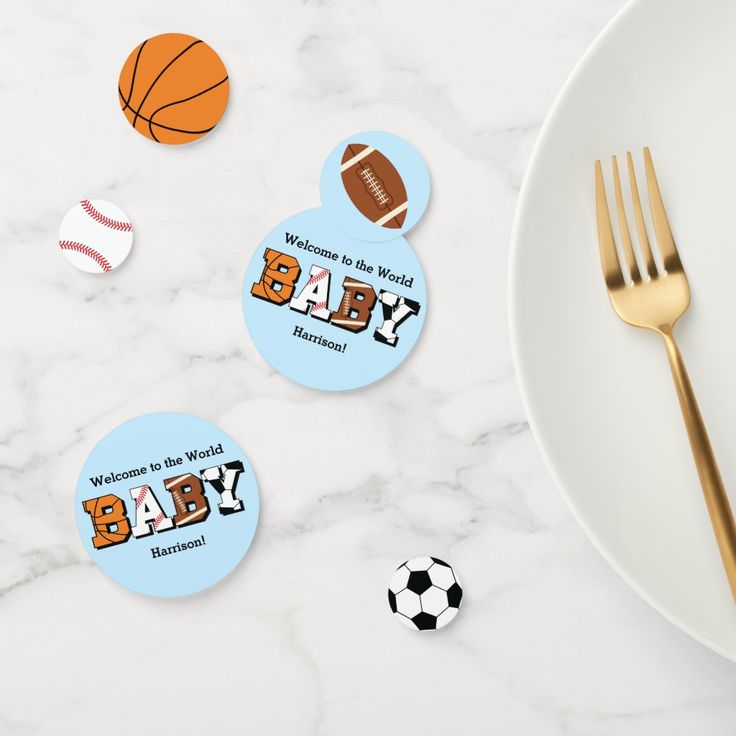 baby shower stickers with sports balls and soccers on them next to a plate