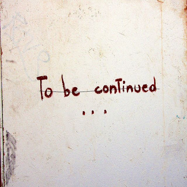 graffiti written on the side of a white wall that says to be confined in red ink