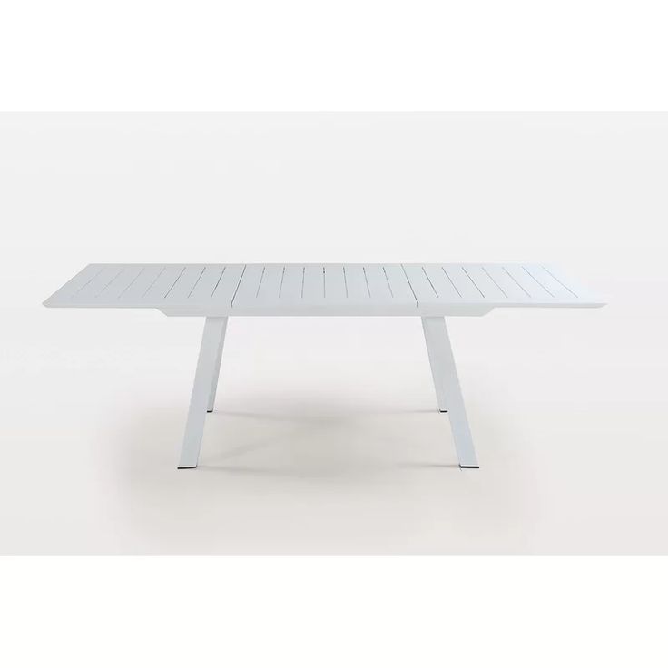 a white table sitting on top of a white floor