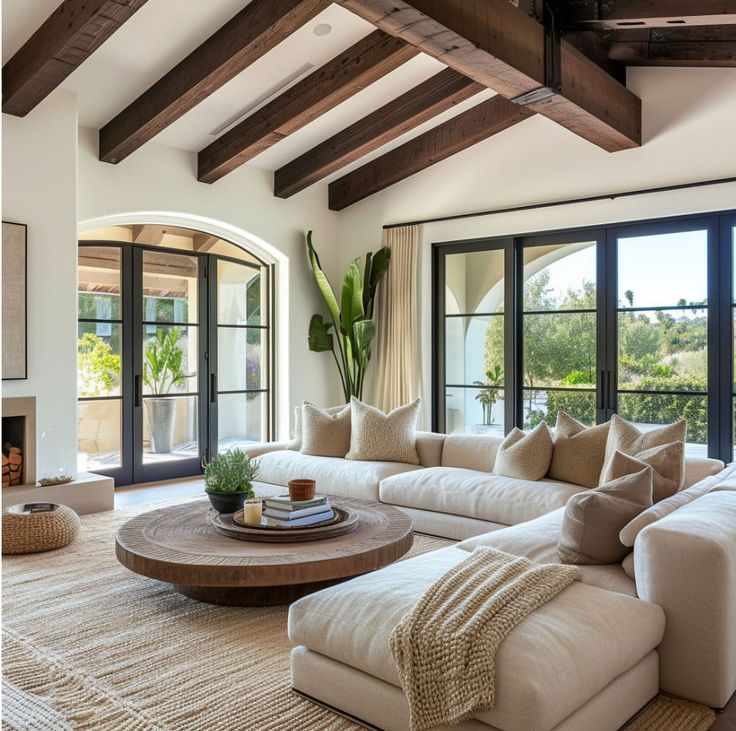 a living room with couches and large windows