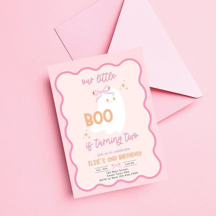 a pink and white birthday party card with an elephant on it's back, sitting next to two envelopes