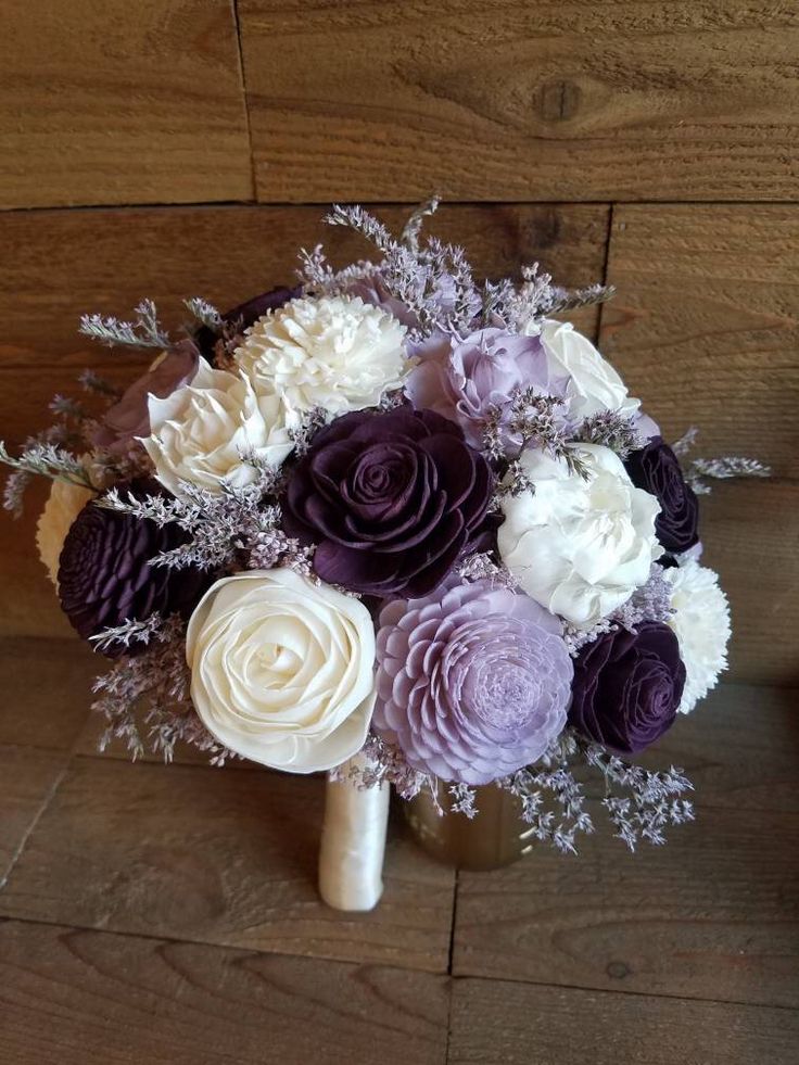 a bridal bouquet with purple and white flowers