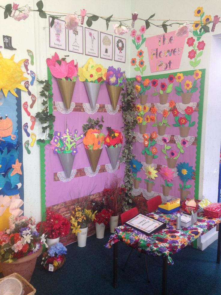 an ice cream shop decorated with paper flowers and decorations on the wall, along with other items