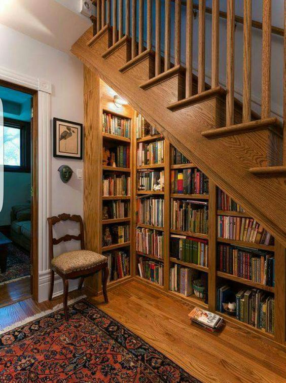 the stairs are made of wood and have bookshelves