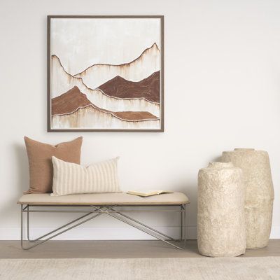 a white couch sitting next to a painting on the wall