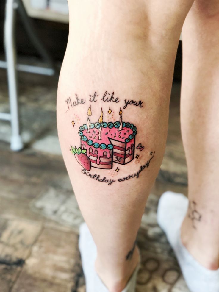 a woman's legs with a birthday cake tattoo on her left leg and the words make it like you