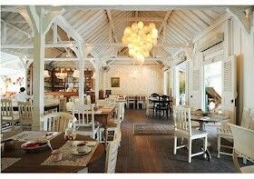 the inside of a restaurant with tables and chairs