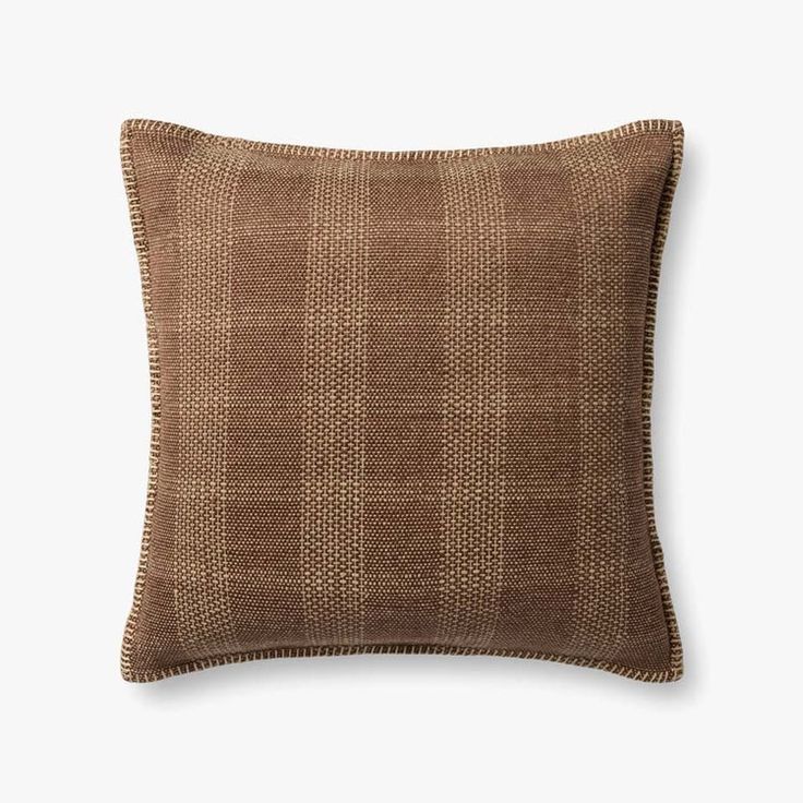 a brown pillow on a white background with a black and tan checkered pattern in the middle